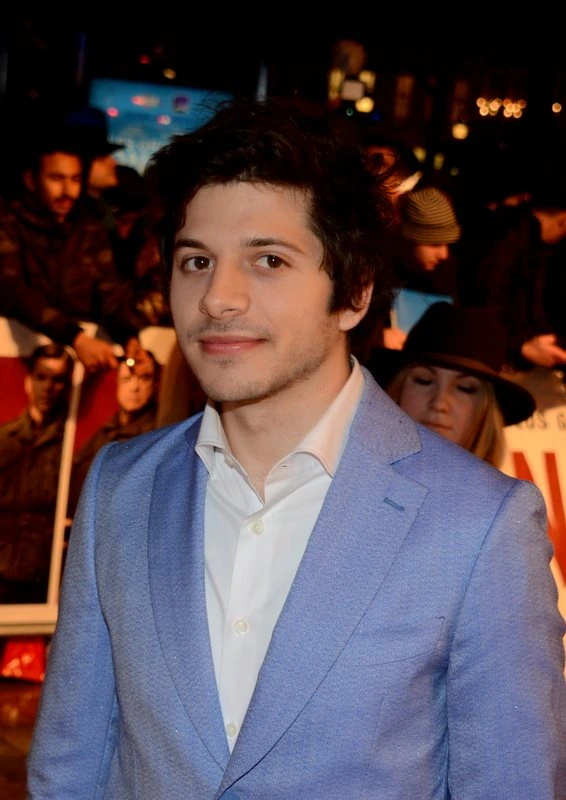 Portrait photo of Dimitri Leonidas at an event, wearing a light blue suit jacket and white shirt.