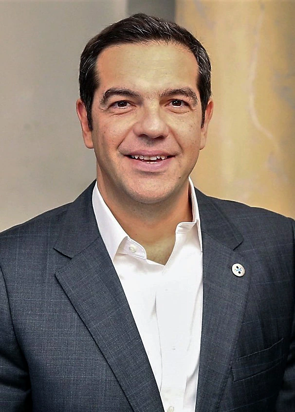 Alexis Tsipras, former Prime Minister of Greece, speaking at a podium