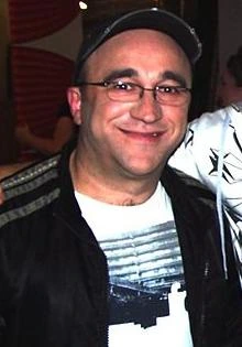 George Kapiniaris smiling in a casual indoor photo